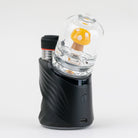 Back view of the yellow mushroom Puffco glass attachment with white spot accents and clear body installed on a black Puffco Peak Pro device