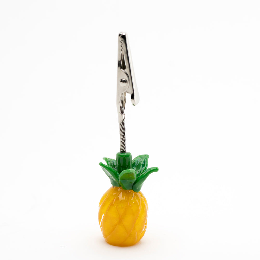 A roach clip with a pineapple base, constructed to hold joints.