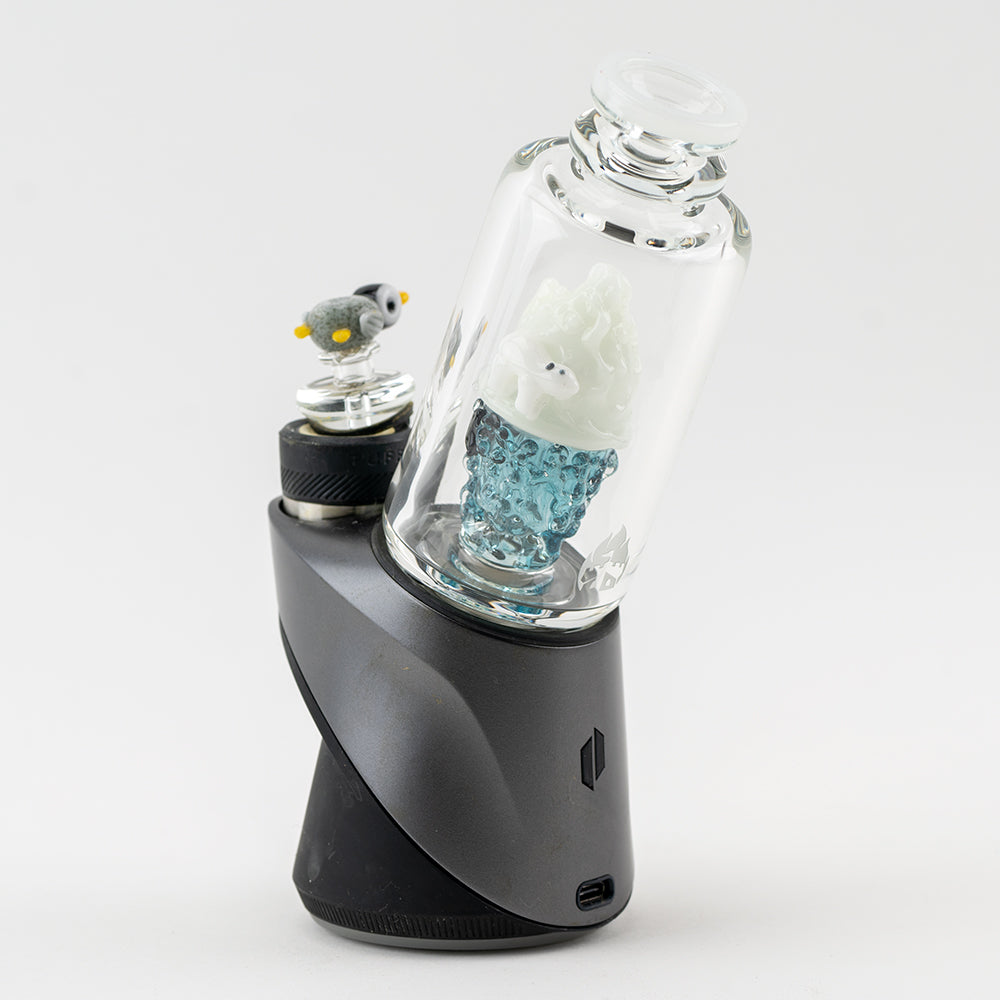 A back image of the puffco peak pro glass attachment. The Puffco peak pro glass features an Artic design with a penguin and Polar Bear. The Puffco Glass also features a glass penguin puffco carb cap. 