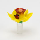 A glass bowl piece designed to resemble a daffodil flower with a ladybug on it, featuring intricate figurine work.